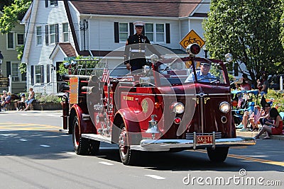 Port Jefferson Station,NY,USA,July4,2019. A Soldier riding a fire truck during the 4th of July Parade. Editorial Stock Photo