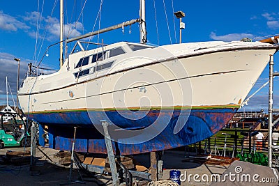 08/30/2020 Port solent, Portsmouth, Hampshire, UK A sailing boat or yacht on silts undergoing repairs to its hull Editorial Stock Photo