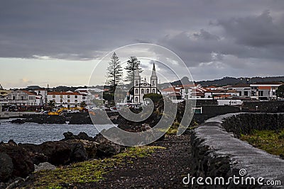 Port town with white church on a lava coast of the island of Pico Editorial Stock Photo