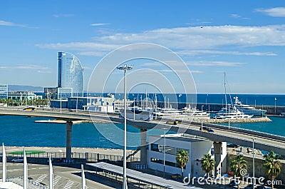 Port Vell with its cruise terminal, marina, bridge Porta d`Europa and W Barcelona Editorial Stock Photo