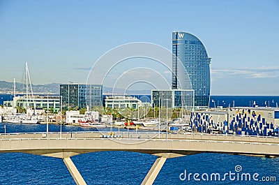 Port Vell with its marina, bridge Porta d`Europa, Nautic Center and W Barcelona Editorial Stock Photo