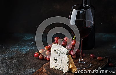 Port wine and blue cheese, still life in rustic style, vintage wooden table background, selective focus Stock Photo