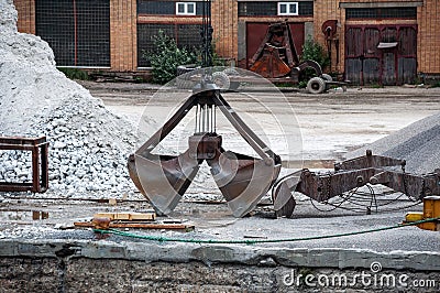 Port work: loading and unloading large piles of sand Stock Photo