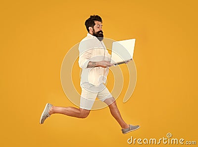 Portability concept. Remote job. Man inspired hold laptop jump. Run with laptop. Hipster bearded manager with laptop Stock Photo