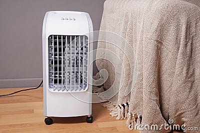 Portable air cooler and humidifier in living room Stock Photo