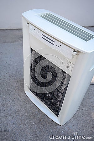 Portable air purifier with dirty carbon filter. Cleaning time Stock Photo