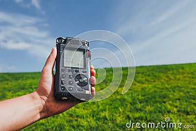 Portable audio recorder in hand field recording ambient sounds of nature Stock Photo