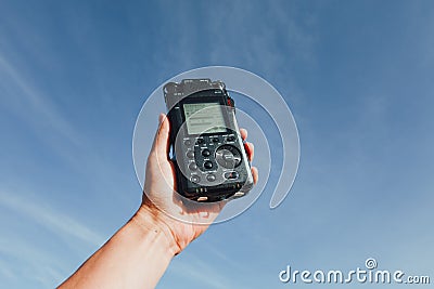 Portable audio recorder in hand recording ambient sounds of nature Stock Photo