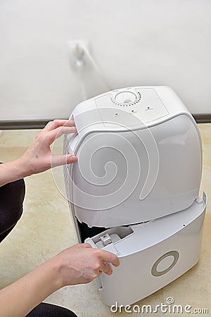 Portable dehumidifier colect water from air Stock Photo