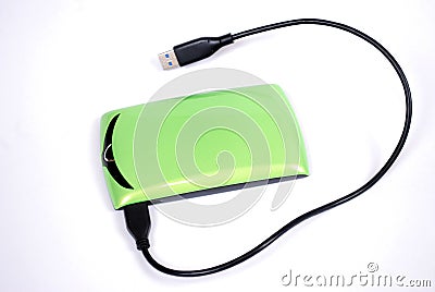 The portable hard drive for the computer with the connected wire on a white background. Stock Photo