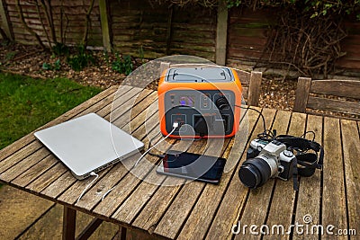 Portable power station solar electricity generator with laptop, tablet and camera charging. Stock Photo