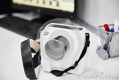 Portable x-ray camera for dentistry white color - standing on the table front view Stock Photo