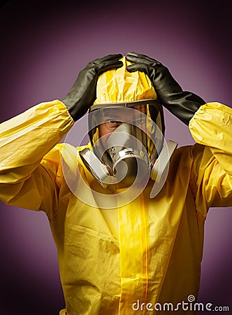 Man wearing a hazmat suit and mask Stock Photo