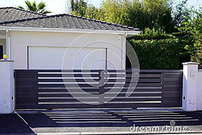 Portal door residential brown sliding home suburb metal aluminum house slide gate street wall Stock Photo