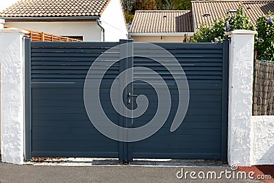 portal double steel high grey metal gate fence on modern house door Stock Photo