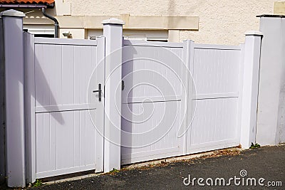 Portal and home door aluminium steel gate white on street access house garden Stock Photo