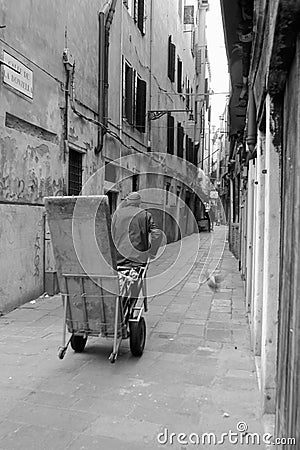 Porter in Venice with Delivery packages on a cart Editorial Stock Photo