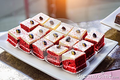 Portion cakes with cream. Dessert red velvet, close-up. Sweets at festive banquet Stock Photo