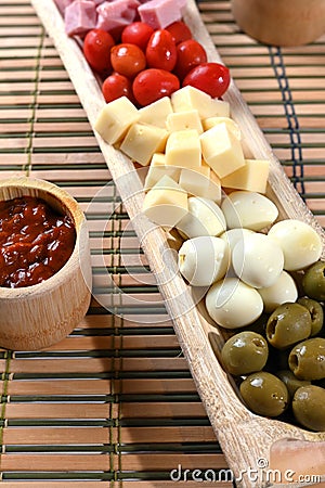 portion of cold snacks cheese ham olive oil Stock Photo