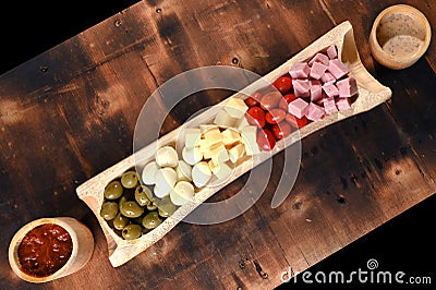 portion of cold snacks cheese ham olive oil Stock Photo