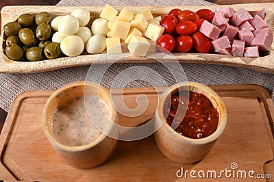 portion of cold snacks cheese ham olive oil Stock Photo