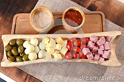 portion of cold snacks cheese ham olive oil Stock Photo