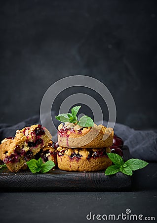 Portion crumble pie with cherries on a wooden board Stock Photo