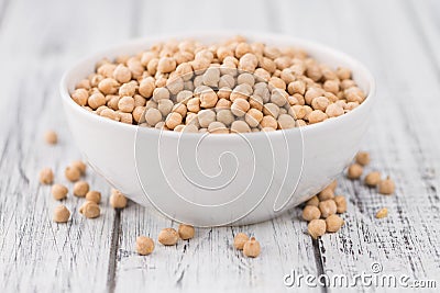 Portion of dried Chickpeas on wooden background, selective focus Stock Photo