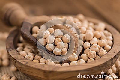 Portion of dried Chickpeas on wooden background, selective focus Stock Photo