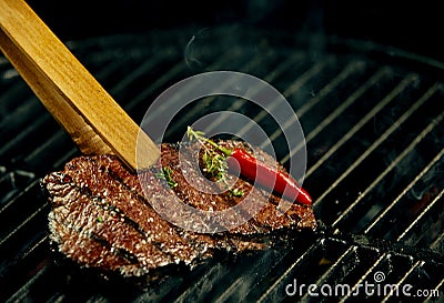 Portion of hot spicy beef steak grilling on a BBQ Stock Photo