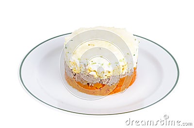 Portion layered salad with fish, carrots and eggs. Stock Photo