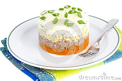 Portion layered salad with fish, carrots and eggs. Stock Photo