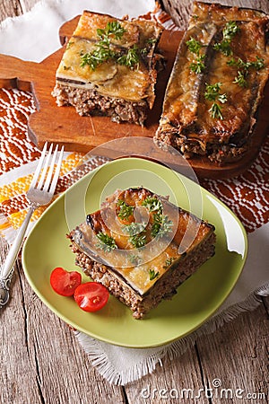 Portion of moussaka with eggplant on a plate close-up. Vertical Stock Photo
