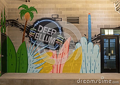 Portion of a mural inside the parking garage of the Novel Apartments featuring the historic Deep Ellum neon sign. Editorial Stock Photo