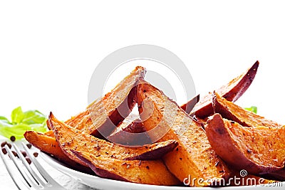 Portion of sweet potato wedges Stock Photo