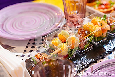 portioned small snacks for a banquet on the festive table. catering Stock Photo