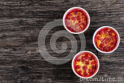 Portions of Cherry clafouti t in ceramic forms Stock Photo