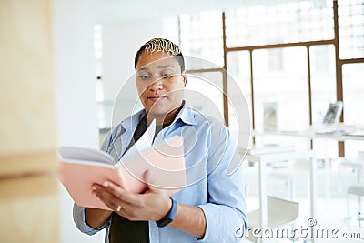 Portly woman in bookshop Stock Photo