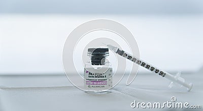 Porto Alegre , Brazil,April 10 - 2021: Botox glass medicine bottle,.Syringe of botulinum toxin, hualuronic, collagen or flu on a Editorial Stock Photo