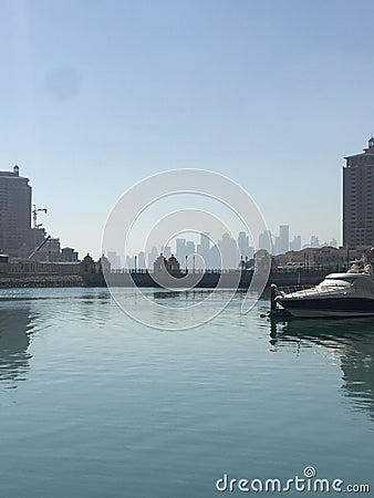 Porto Arabia on the artificial island of The Pearl, with a view of the Doha skyline in the background Editorial Stock Photo