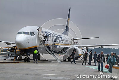 Passengers getting off the plane of Ryanair company at the Porto airport Editorial Stock Photo