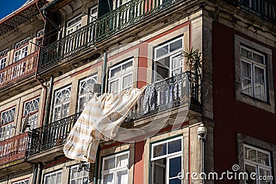 Typical scene in urban Porto, with laundry hanging out to dry on the balcony in downtown area Editorial Stock Photo