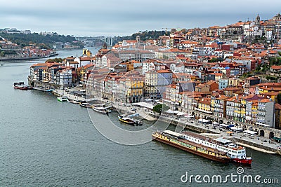 Porto, Portugal, October 31,2020. View on colorful old houses on hill in old part of city and embankment of Douro river in rainy Editorial Stock Photo