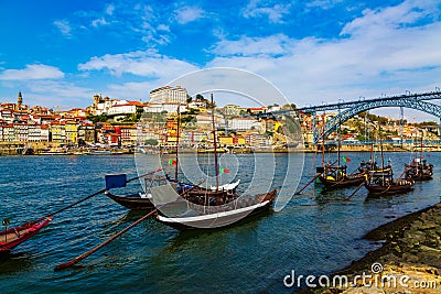 Porto, Portugal, Riberia old town cityscape with Dom Lusi bridge and the Douro River with traditional Rabelo boats Stock Photo