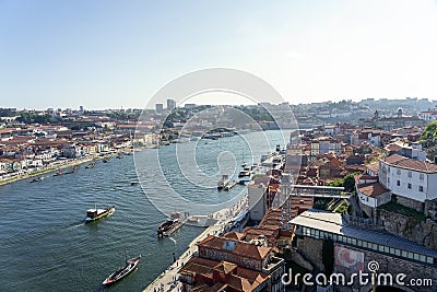 06.22.2023. Porto, Portugal: riverside of Duero river cityscape at sunset from above with tourists Editorial Stock Photo