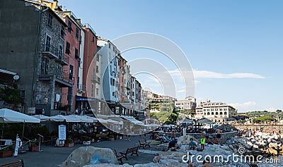 Portovenere, Liguria, Italy. June 2020. View of the promenade in front of the beautiful houses with colorful facades: young people Editorial Stock Photo