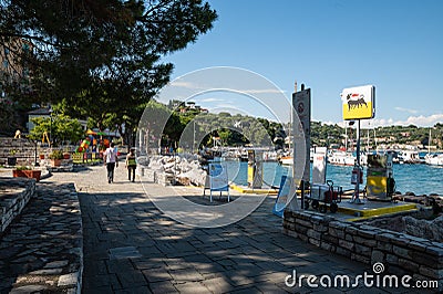 Portovenere, Liguria, Italy. June 2020. View of the seascape: on the waterfront a petrol station, moored boats, the green hills Editorial Stock Photo