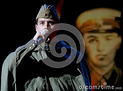 Portra Soviet soldier, poet, hero in uniform of World War II playing the accordion over black background. Editorial Stock Photo