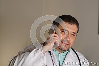 Portrait of absorbed doctor talking on his mobile phone Stock Photo