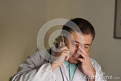 Portrait of absorbed doctor talking on his mobile phone Stock Photo